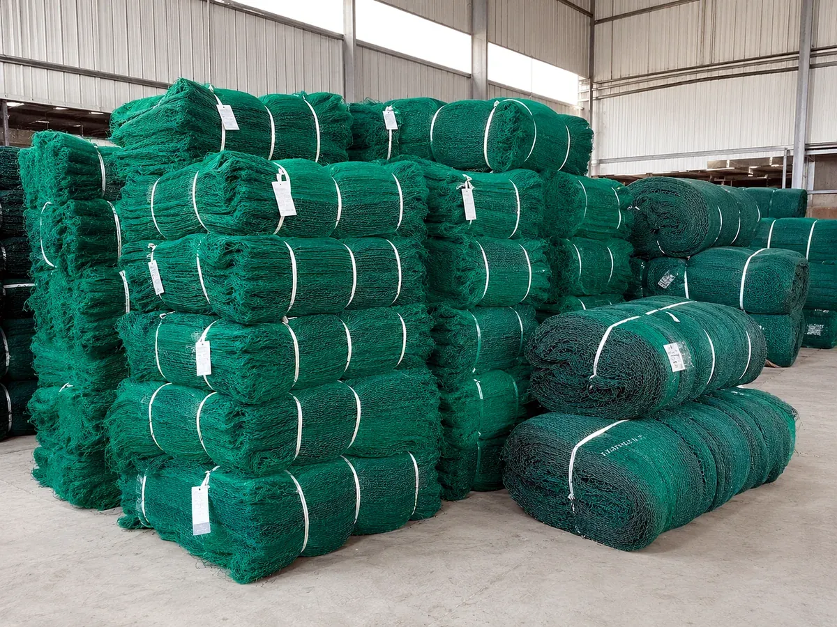 Semi-finished fishing net bales and rolls stacked in export warehouse