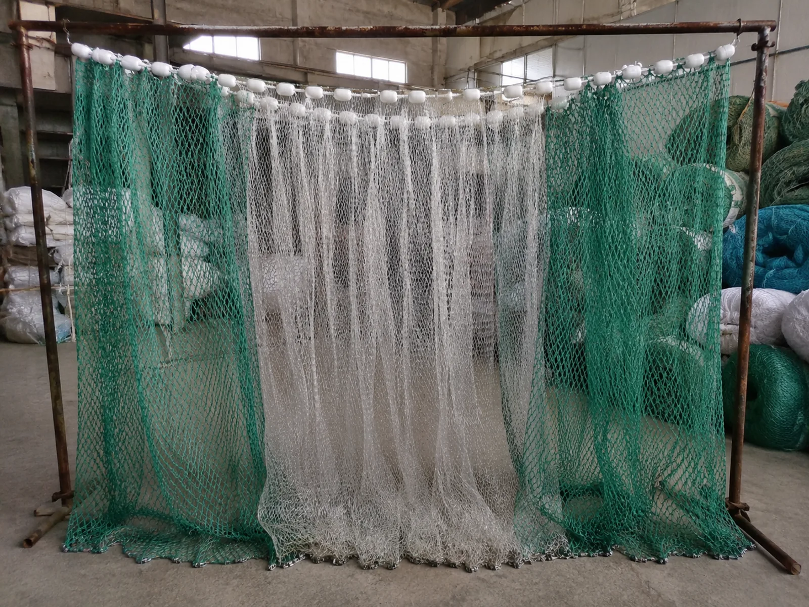 Finished fishing nets with floats hanging for inspection