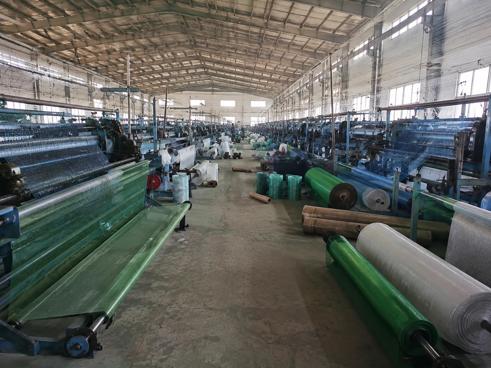Fishing netting workshop with net making machines and PE net rolls