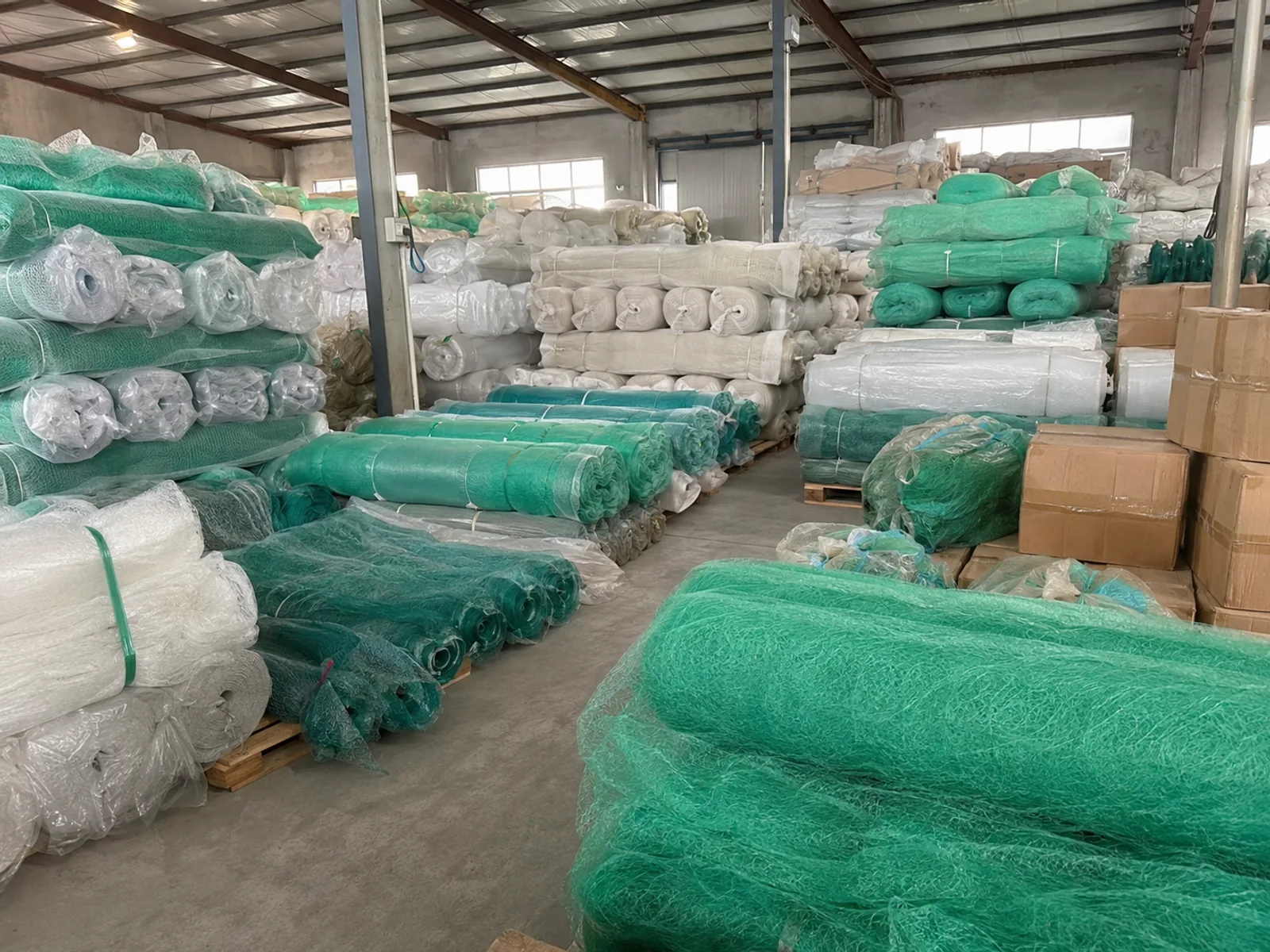 Semi-finished fishing net rolls and bales stored in export warehouse
